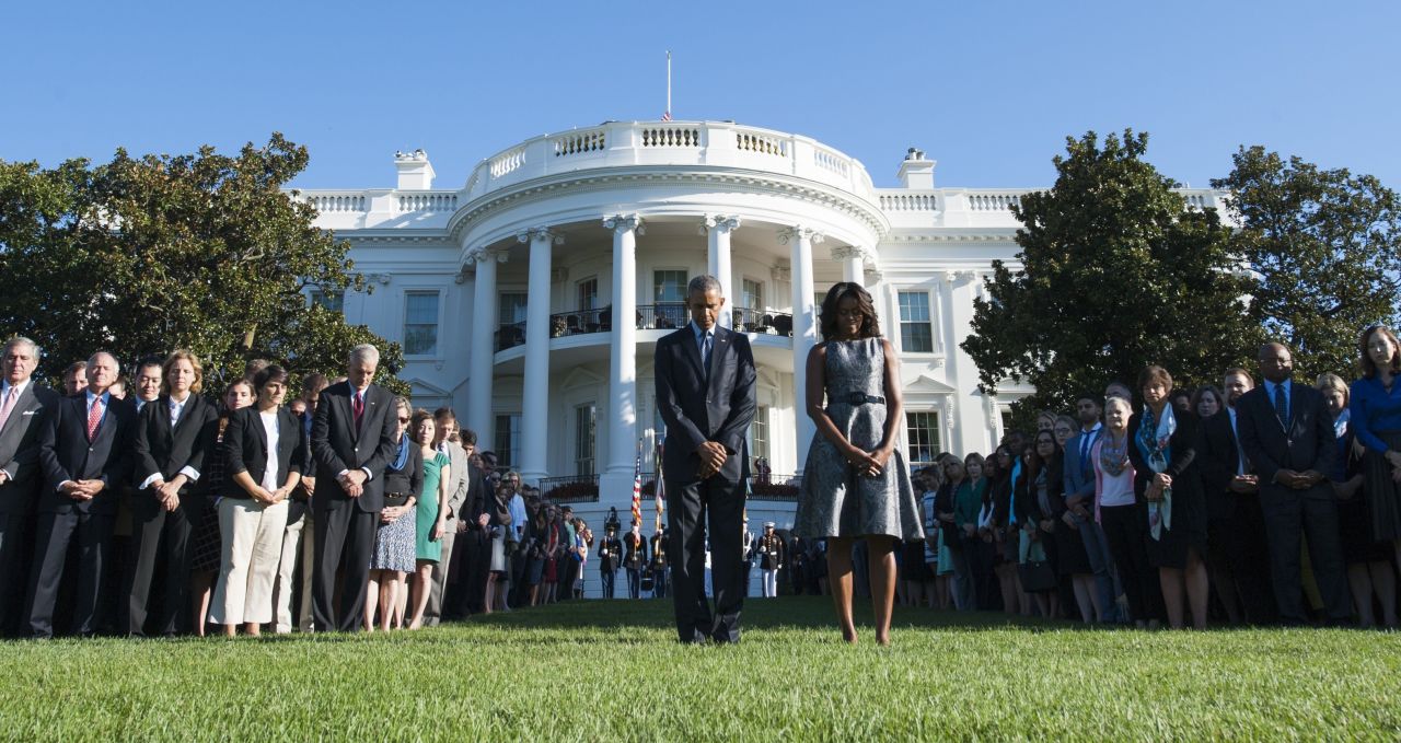 President Barack Obama and first lady Michelle Obama lead a moment of silence on the White House South Lawn at 8:46 a.m. Friday -- the time when the first hijacked plane hit the World Trade Center on 9/11.