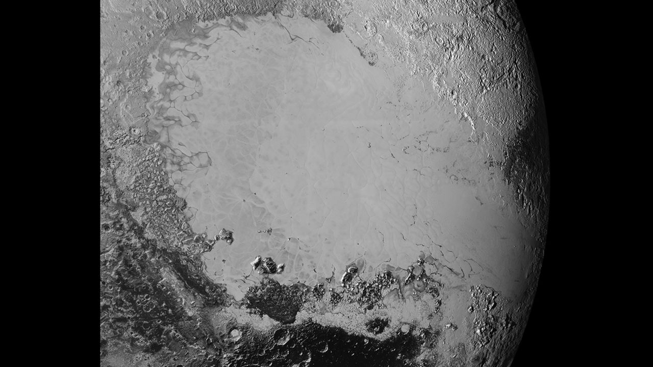 Scientists say that what looks like mountains could be huge blocks of frozen water suspended in frozen nitrogen. On the new photos, taken on July 14 and released on September 10, a pixel is 400 meters (440 yards). New Horizons' closest pass by Pluto took it about 50,000 miles from the surface.