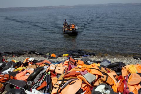 Discarded life jackets line the rocky shores of Lesbos, Greece on September 10, 2015. The remnants of inflatable boats also litter the beach. Migrants are advised to slash their rafts when they arrive so that authorities can't push them back to sea.
