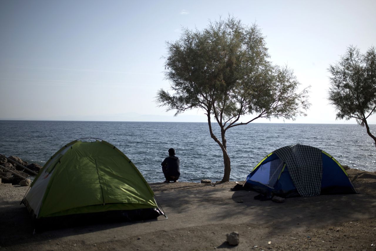 Migrants buy tents to make their journey more comfortable. A Facebook page for refugees even tells them what sort to buy and where. Here, a migrant looks out to sea.