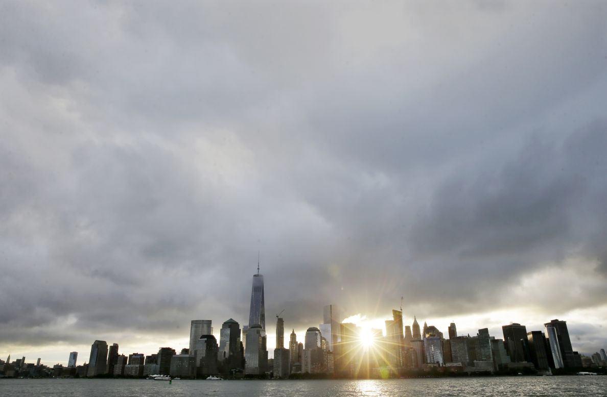 The sun rises over Lower Manhattan and One World Trade Center, at left, on Friday, September  11, in a view from Jersey City, New Jersey. The nation is marking the 14th anniversary of 9/11, the deadliest terrorist attack on U.S. soil. Nearly 3,000 people died that day. See other images of 9/11 events: