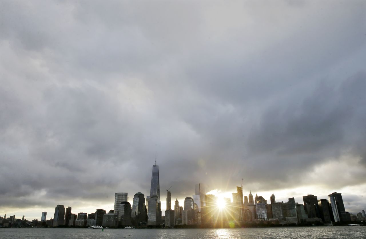 The sun rises over Lower Manhattan and One World Trade Center, at left, on Friday, September  11, in a view from Jersey City, New Jersey. The nation is marking the 14th anniversary of 9/11, the deadliest terrorist attack on U.S. soil. Nearly 3,000 people died that day. See other images of 9/11 events: