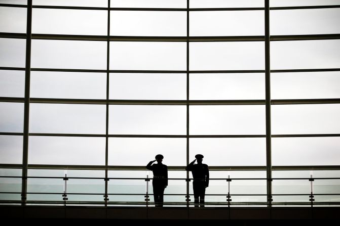 Honor guards salute during the national anthem in a 9/11 ceremony Friday at Indianapolis International Airport. 