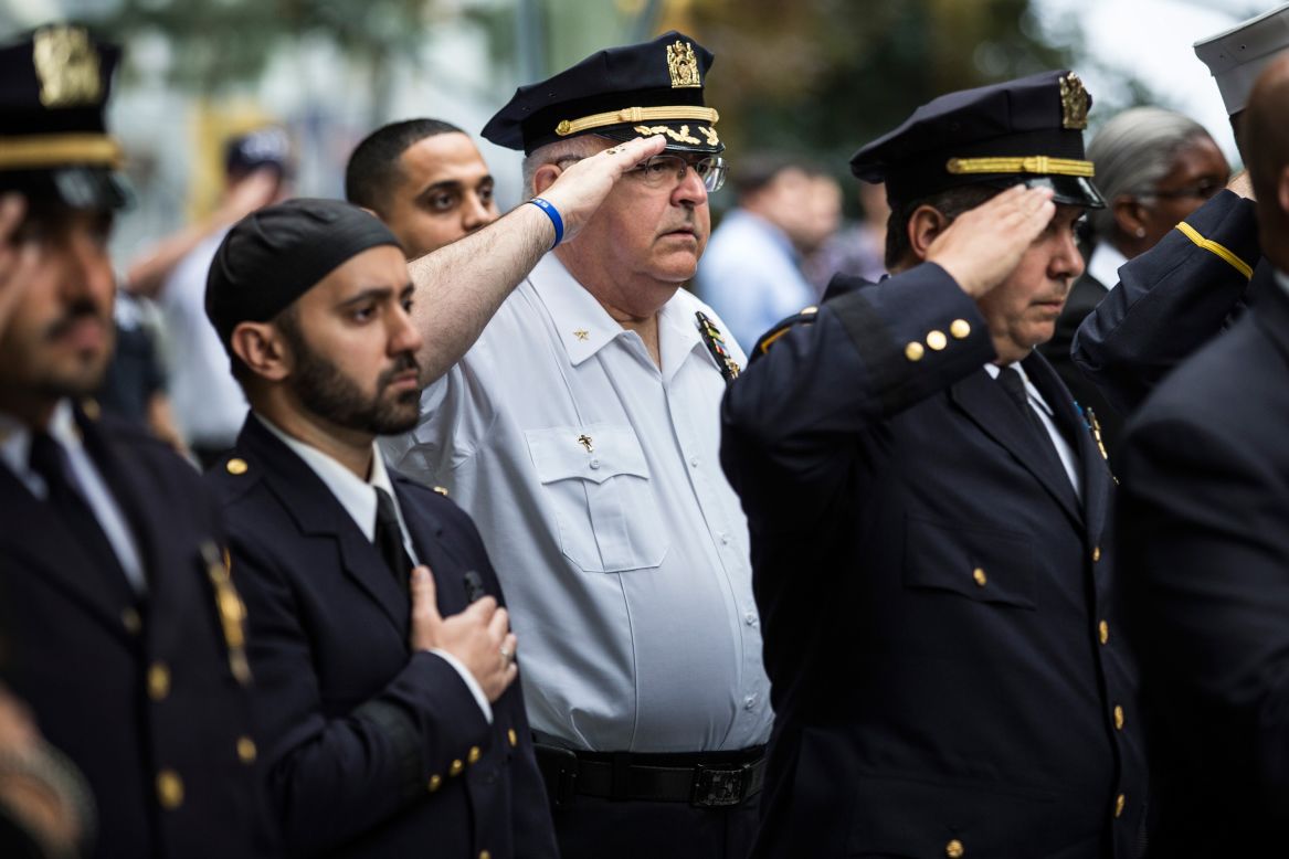 Law enforcement officials stand at attention Friday during the national anthem in an anniversary ceremony in New York in commemoration of the 9/11 attacks.