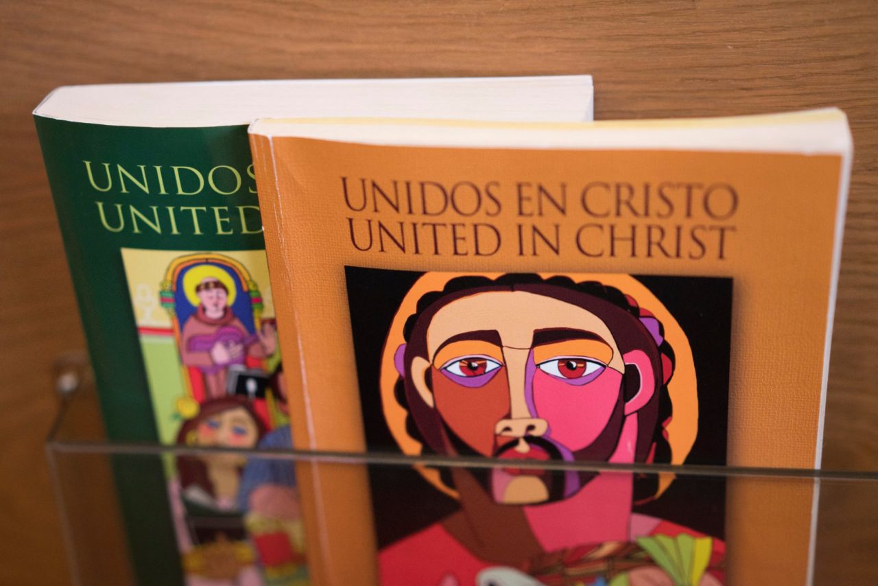 Long before Saint Charles Borromeo celebrated its first Mass entirely in Spanish, Msgr. Edward Deliman ordered bilingual books for the pews. "We introduced it as just something for the people to see," he says.
