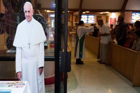 At Saint Charles Borromeo, enthusiasm for the Pope's upcoming visit has been growing. A cardboard cutout of the smiling pontiff stands near an entrance to the church.
