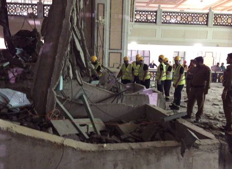 Civil Defense personnel inspect the damage at the mosque.