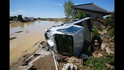 A truck and a house are damaged after floods hit Joso, Ibaraki prefecture, northeast of Tokyo, Friday, Sept. 11, 2015. The sun came out a day after a raging river washed away houses and forced people to rooftops as dozens of residents were airlifted out by military helicopters Friday morning after waiting overnight in the city. (AP Photo/Shizuo Kambayashi)