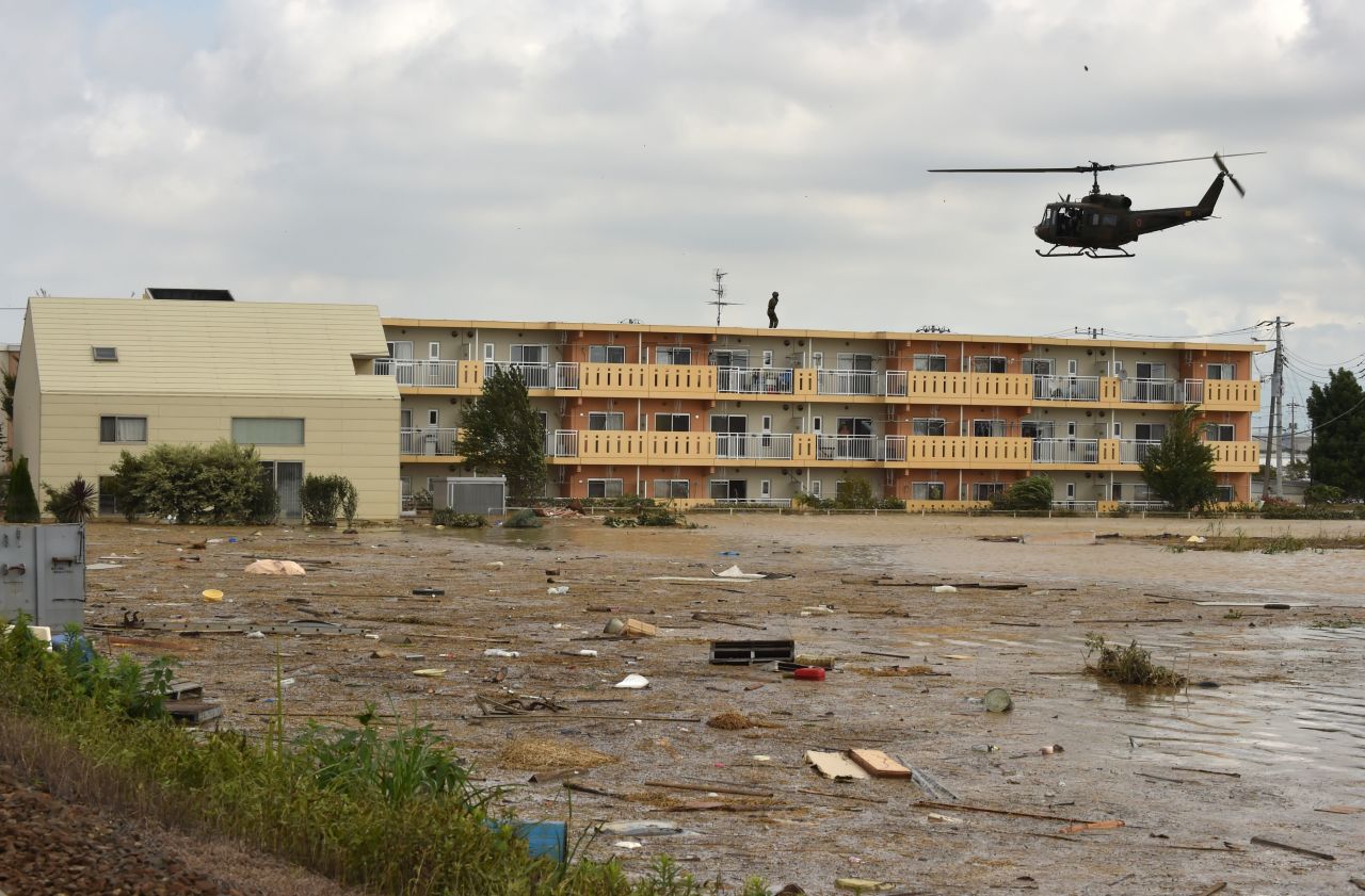 A military helicopter prepares to land on the roof of an apartment building during a rescue mission in the city of Joso in Ibaraki prefecture on Saturday, September 12. 