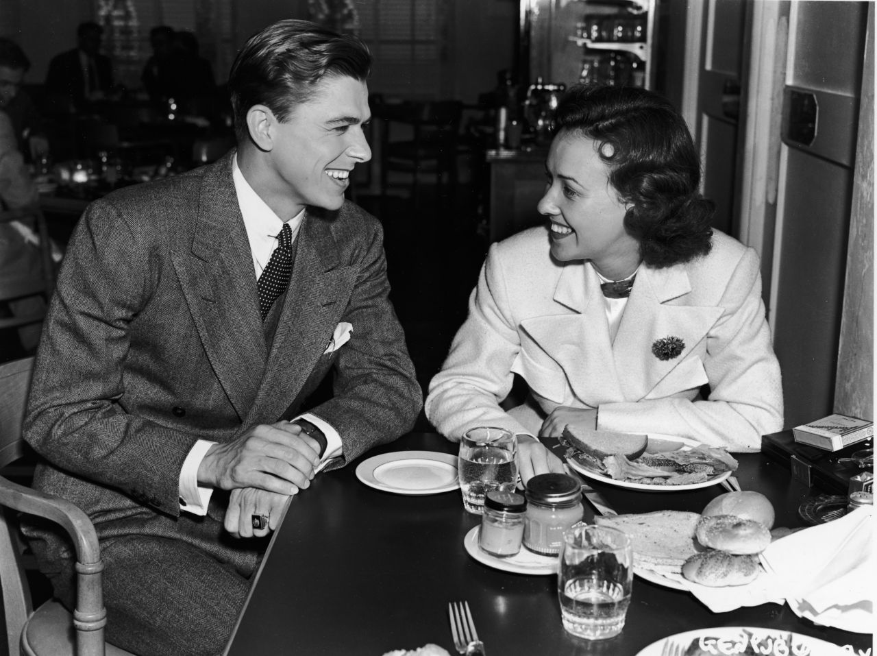 After starting out as a radio sports broadcaster, Reagan worked his way into the acting profession. Here, he sits with actress Margaret Lindsay in the Warner Brothers Studio commissary in 1935.