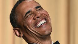 Barack Obama laughs as he listens to performer Joel McHale telling jokes during the White House Correspondents Association Dinner on May 3, 2014 in Washington, DC.