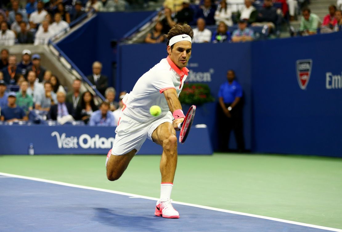 Federer returns a backhand shot to Djokovic.