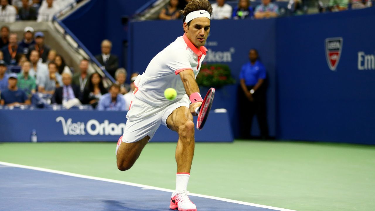 Federer returns a backhand shot to Djokovic.