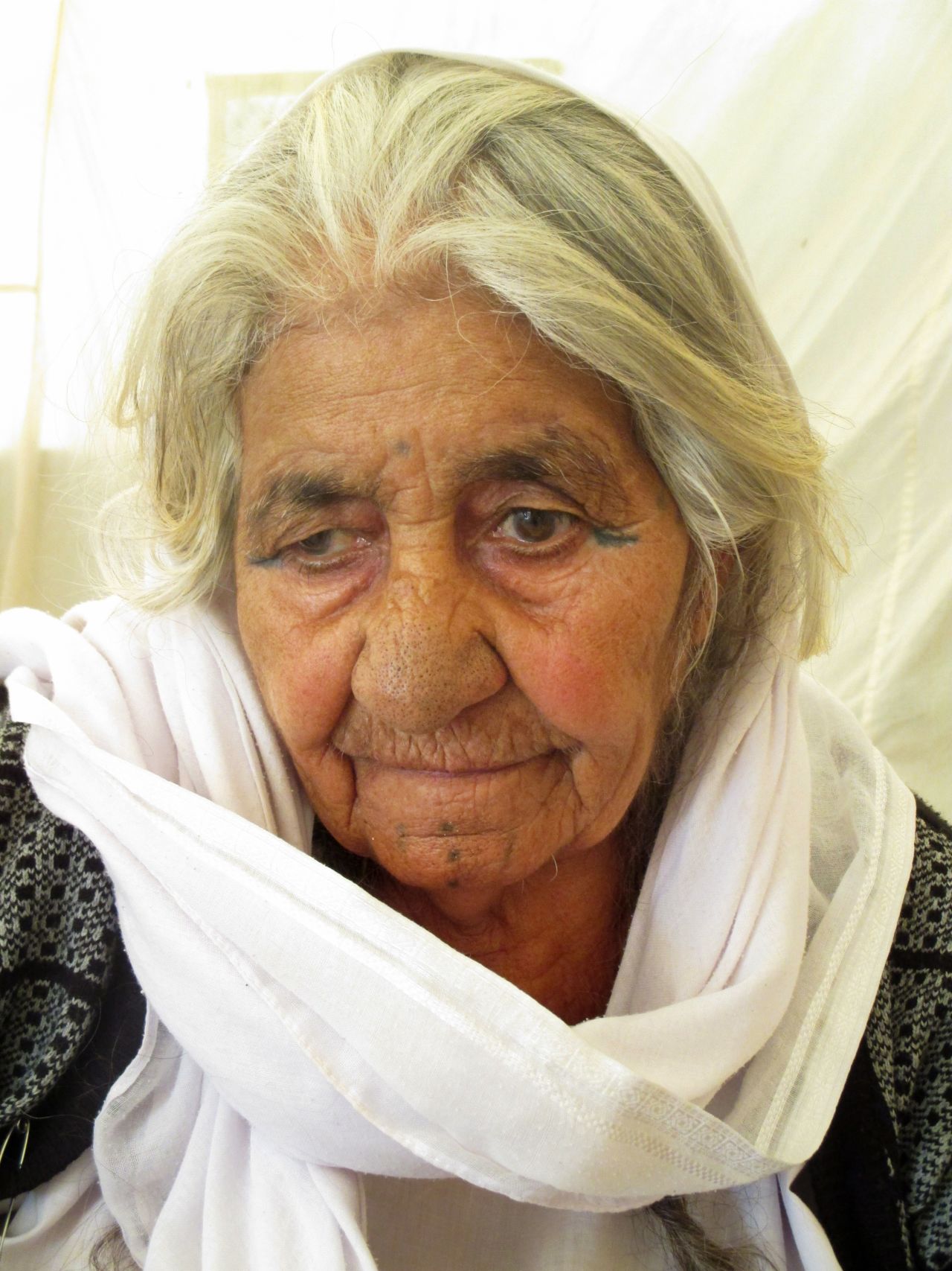 Bushra, 16, took portraits of Yazidis in the camp where she lives, including this old Yazidi woman.