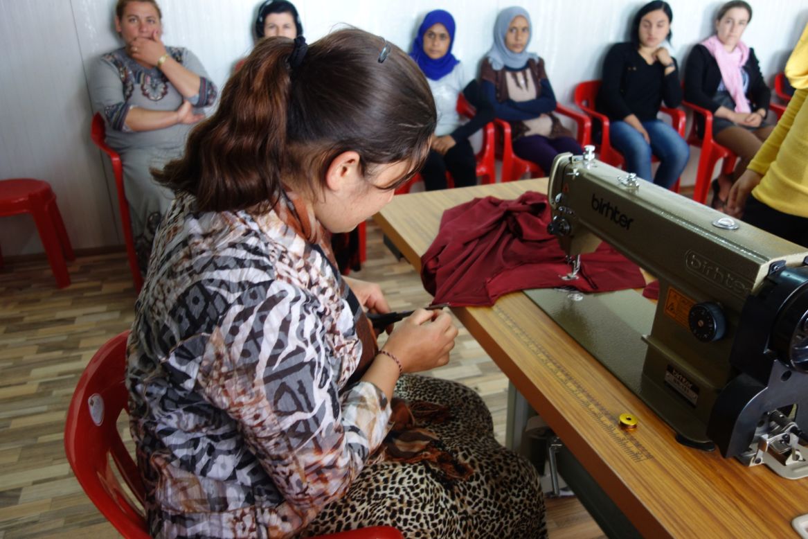19-year-old Zina took this picture during a dress making course. "It's a favorite picture because this woman [was] working as a tailor ... she doesn't give up." 