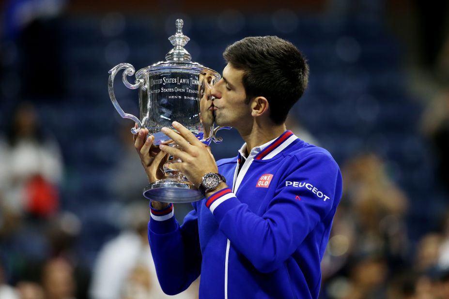 Novak Djokovic gives the trophy a kiss after defeating Roger Federer in the U.S. Open men's final on September 13, 2015 in New York.