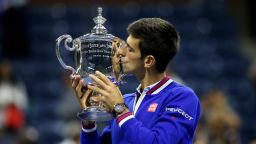 Novak Djokovic of Serbia celebrates with the winner's trophy after defeating Roger Federer of Switzerland during their Men's Singles Final match on Day Fourteen of the 2015 US Open at the USTA Billie Jean King National Tennis Center on September 13, 2015 in the Flushing neighborhood of the Queens borough of New York City. Djokovic defeated Federer 6-4, 5-7, 6-4, 6-4.