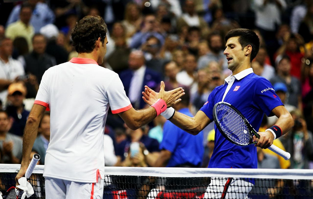 Djokovic shakes hands with Federer after winning his 10th grand slam title, avenging his defeat to the Swiss eight years ago.