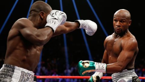Floyd Mayweather dodges a punch from Andre Berto during their welterweight title fight in Las Vegas on Saturday, September 12. Mayweather won by unanimous decision and said he will retire with his undefeated record of 49-0.