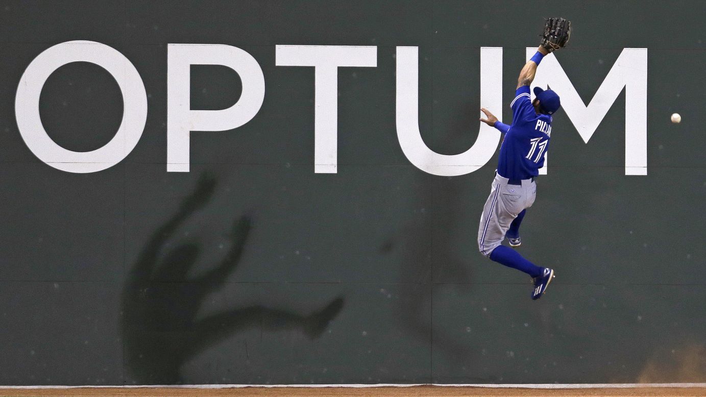 Toronto Blue Jays center fielder Kevin Pillar leaps for a catch near Boston's left-field wall on Wednesday, September 9.