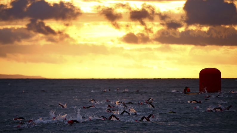 Athletes swim during an Ironman competition in Pembroke, Wales, on Sunday, September 13.