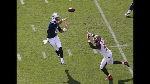 Tennessee quarterback Marcus Mariota throws over a Tampa Bay defender during an NFL game in Tampa, Florida, on Sunday, September 13. Mariota, the Heisman Trophy winner who went second overall in this year's draft, threw four touchdowns in his NFL debut as the Titans won 42-14.