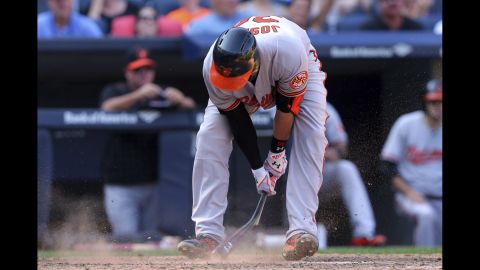Baltimore Orioles catcher Caleb Joseph breaks his bat on the ground after striking out in New York on Monday, September 7.