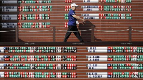 A staff member walks in front of the scoreboard at the Evian Championship, a women's golf tournament in Evian, France, on Saturday, September 12.