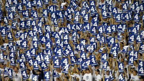 BYU football fans hold up signs during the fourth quarter of a home game in Provo, Utah, on Saturday, September 12. The signs paid respect to BYU quarterback Taysom Hill, who wears No. 4 and is out for the season with a foot injury.