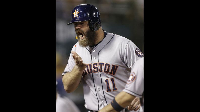 Houston's Evan Gattis throws gummy bears into his mouth after hitting a home run in Oakland, California, on Wednesday, September 9. A teammate <a href="index.php?page=&url=http%3A%2F%2Fm.mlb.com%2Fcutfour%2F2015%2F09%2F10%2F148438470" target="_blank" target="_blank">handed him the snack</a> at home plate.
