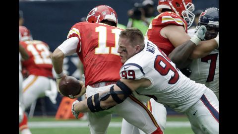 Despite losing his helmet on the play, Houston's J.J. Watt sacks Kansas City's Alex Smith during an NFL game in Houston on Sunday, September 13.