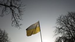 An Ukrainian flag flies in central Kiev, Monday, Feb. 24, 2014. Ukraine's acting government issued a warrant Monday for the arrest of President Viktor Yanukovych, last reportedly seen in the pro-Russian Black Sea peninsula of Crimea, accusing him of mass crimes against protesters who stood up for months against his rule. (AP Photo/Marko Drobnjakovic)