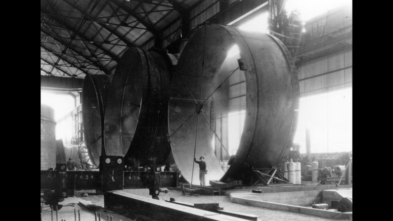 A man stands inside part of one of the dam's enormous turbines. Construction of the dam took less than five years and was completed in 1936. The American Society of Civil Engineers named Hoover Dam one of "Seven Modern Civil Engineering Wonders" in 1955, along with such landmarks as the Empire State Building and the Panama Canal.