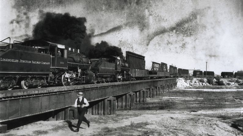 A Union Pacific Railroad train, carrying sections of the dam's steel gates, pulls out of Los Angeles en route to the dam site. Each gate section weighed about 36 tons, and when an entire gate was assembled it weighed 2,880 tons. 