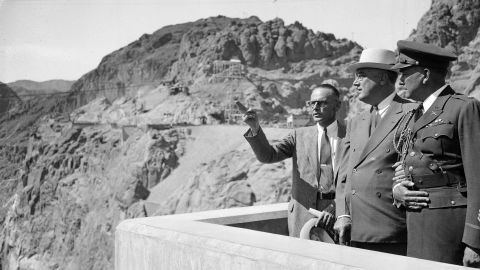 President Franklin D. Roosevelt views the dam for the first time at its dedication on September 30, 1935. At left is Walker Young, who was in charge of the project for the US Bureau of Reclamation. At right is a military aide to the President.