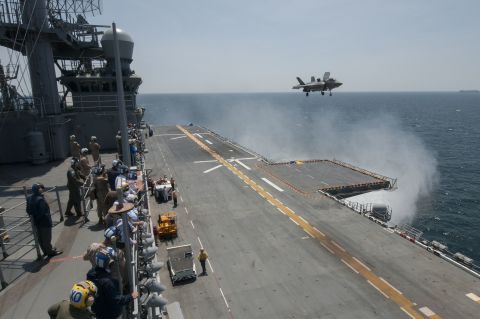 Sailors and distinguished visitors watch an F-35B Lightning II aircraft conduct vertical takeoff and landing flight operations aboard the amphibious assault ship USS Wasp in May 2015. Click through the gallery to see more images from the testing.