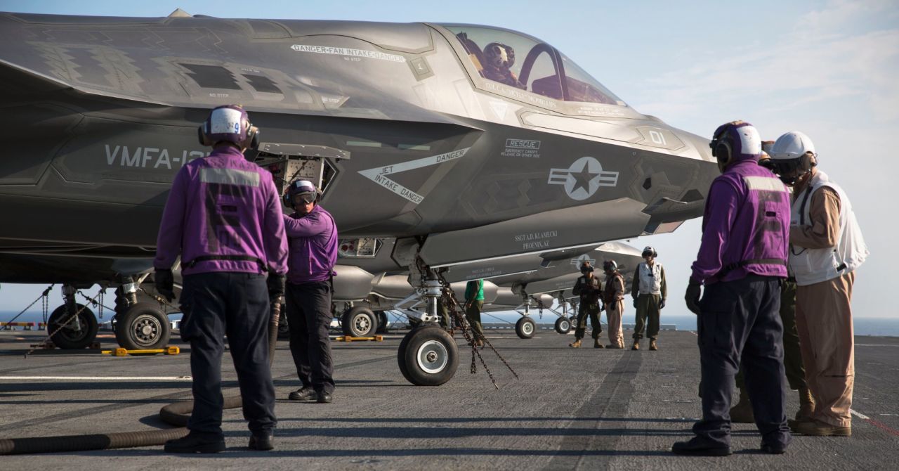 Marines and sailors aboard the amphibious assault ship USS Wasp secure and refuel an F-35B Lightning II fighter after its arrival for the first session of operational testing.
