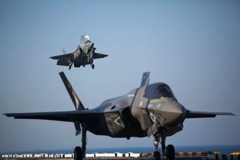Two F-35B Lightning II fighters complete vertical landings aboard the amphibious assault ship USS Wasp during the opening day of the first session of operational testing in May 2015. As the future of Marine Corps aviation, the F-35B is designed to eventually replace all aircraft from three legacy Marine Corps platforms; the AV-8B Harrier, the F/A-18 Hornet, and the EA-6B Prowler. 