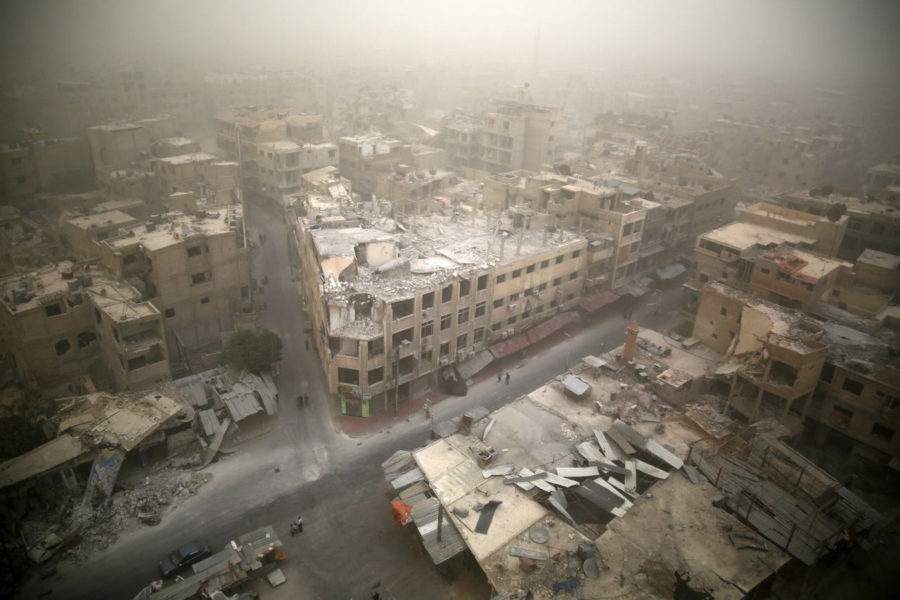 A sandstorm blows over damaged buildings in the rebel-held area of Douma, east of Damascus, on September 7, 2015.
