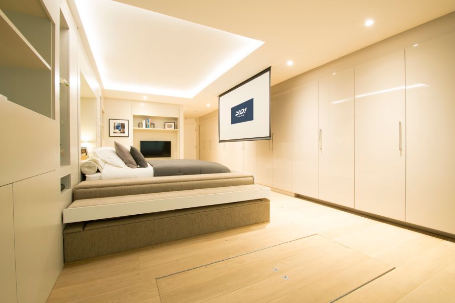 The home then turns into a bedroom with a cinema screen on the opposite wall. 