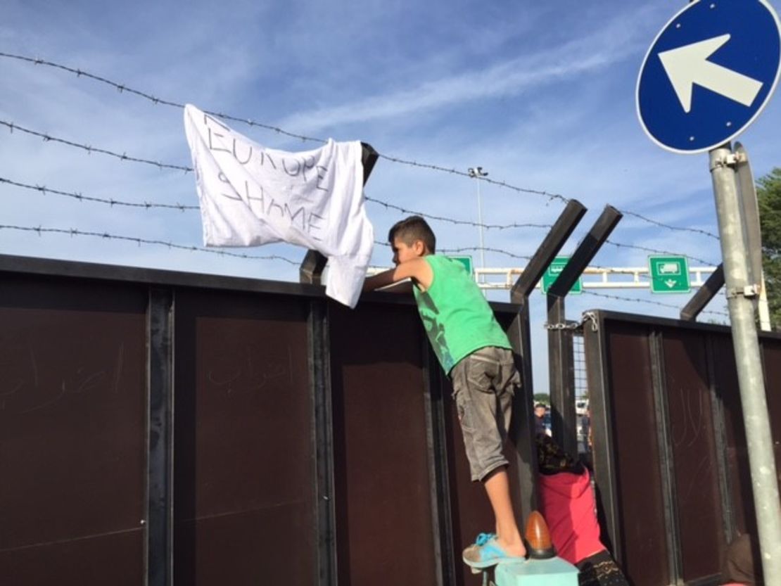 Migrant children in Serbia peer across the border to Hungary.