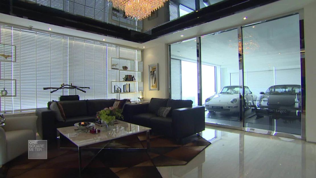 Two parked cars in overlook the living area of a Hamilton Scotts apartment.