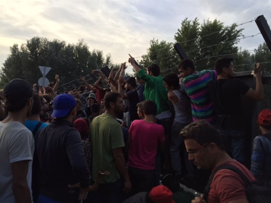 Migrants gathered at the Serbian-Hungarian border chant, "Open, open."