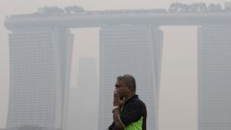 A man covers his nose from the air pollution in Singapore