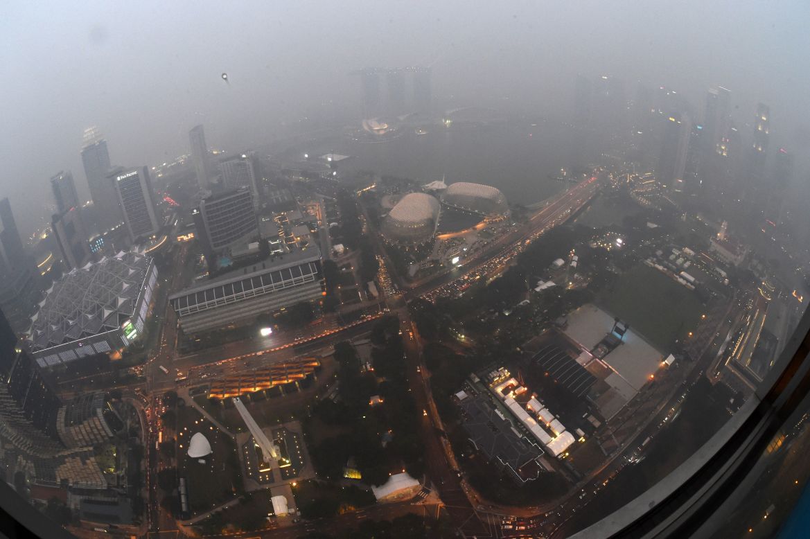 City lights pierce through the dense haze in Singapore on September 14, 2015.