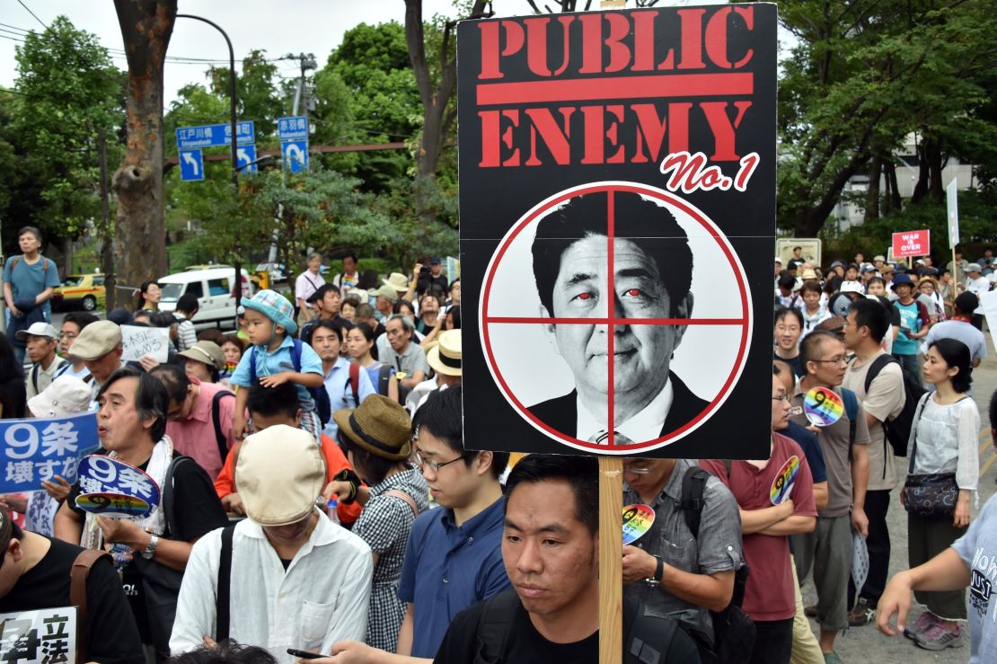 Civic group members hold placards during an anti-government rally in Tokyo on August 23, 2015.
