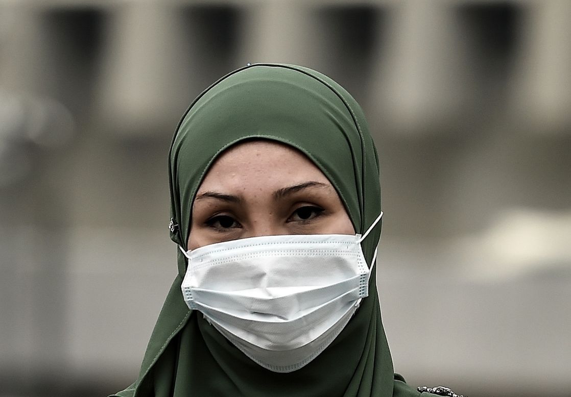 A woman shields herself from the soupy haze with a face mask in Kuala Lumpur, Malaysia on September 15. Malaysian authorities ordered 2,045 schools in the capital and neighboring states to close on Monday after the Air Pollutant Index (API) soared to "very unhealthy" levels.