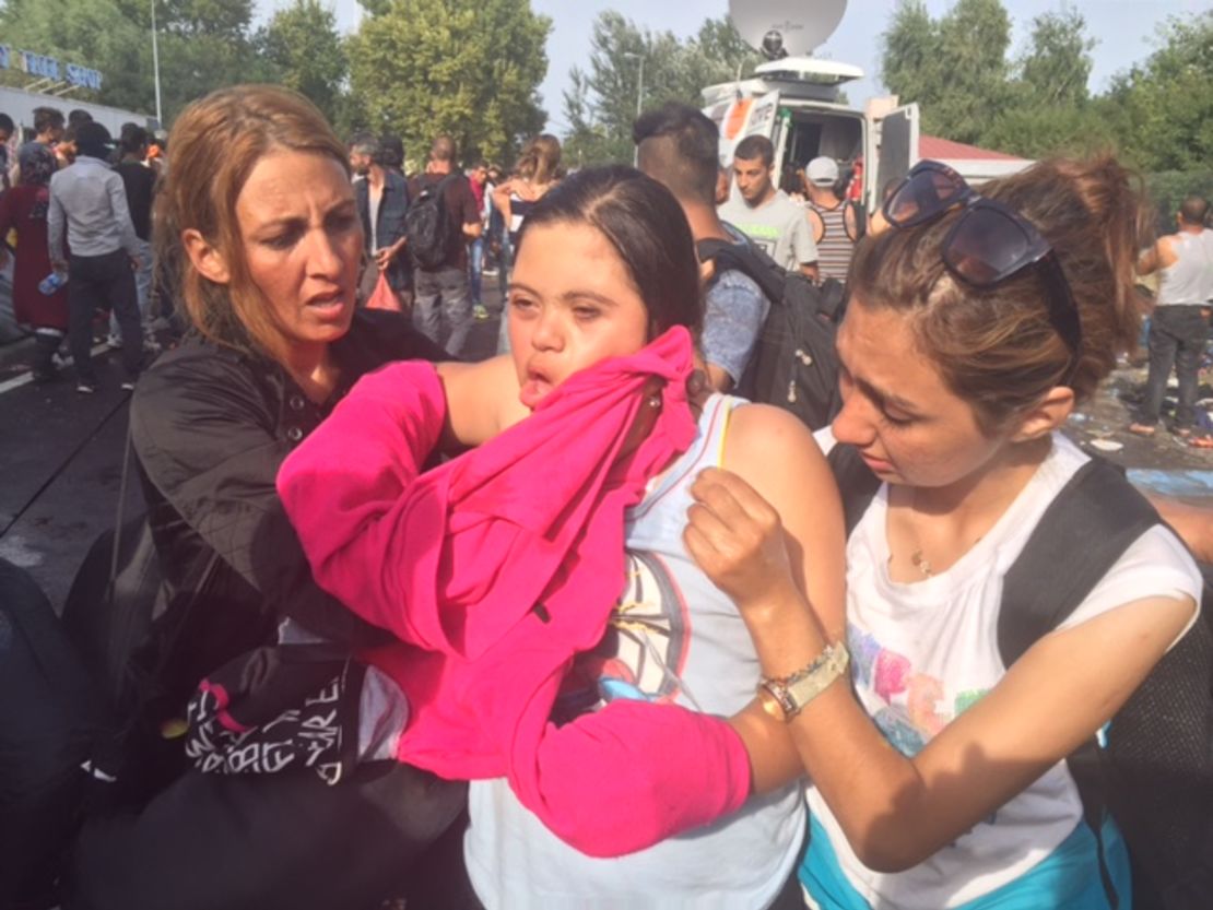 A migrant receives help after Hungarian authorities use tear gas on the Serbian border.