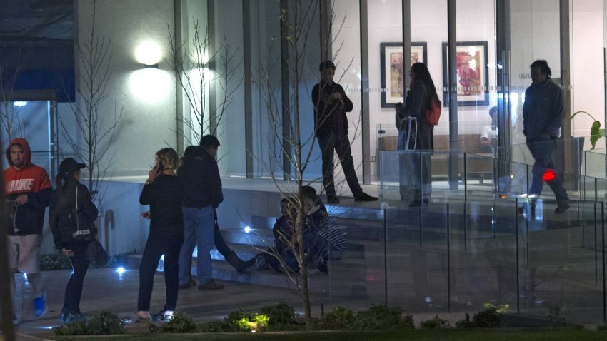 People remain outside a building during a strong quake in Santiago on September 16, 2015. A strong 7.2-magnitude earthquake struck the center of Chile on Wednesday, local seismologists said, triggering a tsunami alert, sparking panic and shaking buildings. AFP PHOTO /VLADIMIR RODAS        (Photo credit should read VLADIMIR RODAS/AFP/Getty Images)
