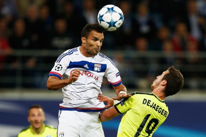 Jeremy Morel of Lyon towers over Gent's Brecht Dejaegere as he clears the ball.